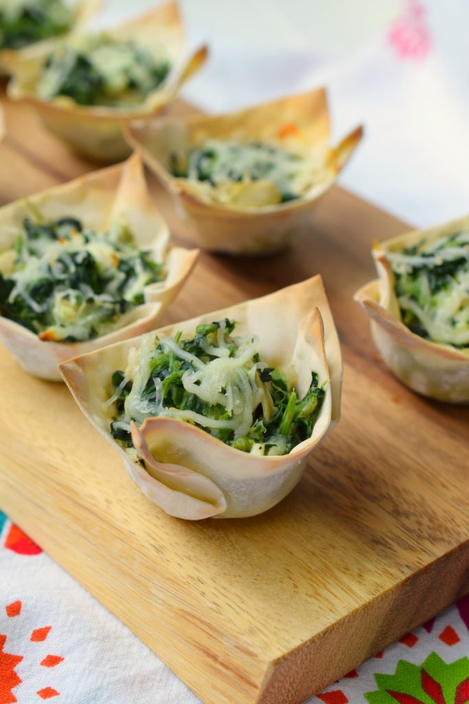 Spinach Artichoke Wonton Cups are party perfect! Bite-sized and easy to prepare, they are loaded with delicious flavors. They are a great holiday appetizer!