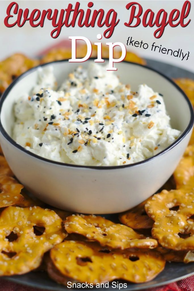 white bowl of everything bagel dip with pretzel chips surrounding